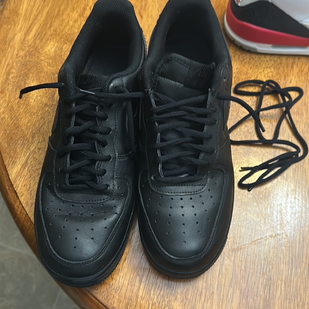 Black on black Nike Air Force ones. 8.5